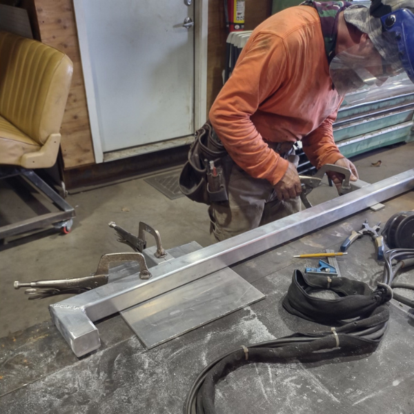 certified welding experts working on a part to be powder coated